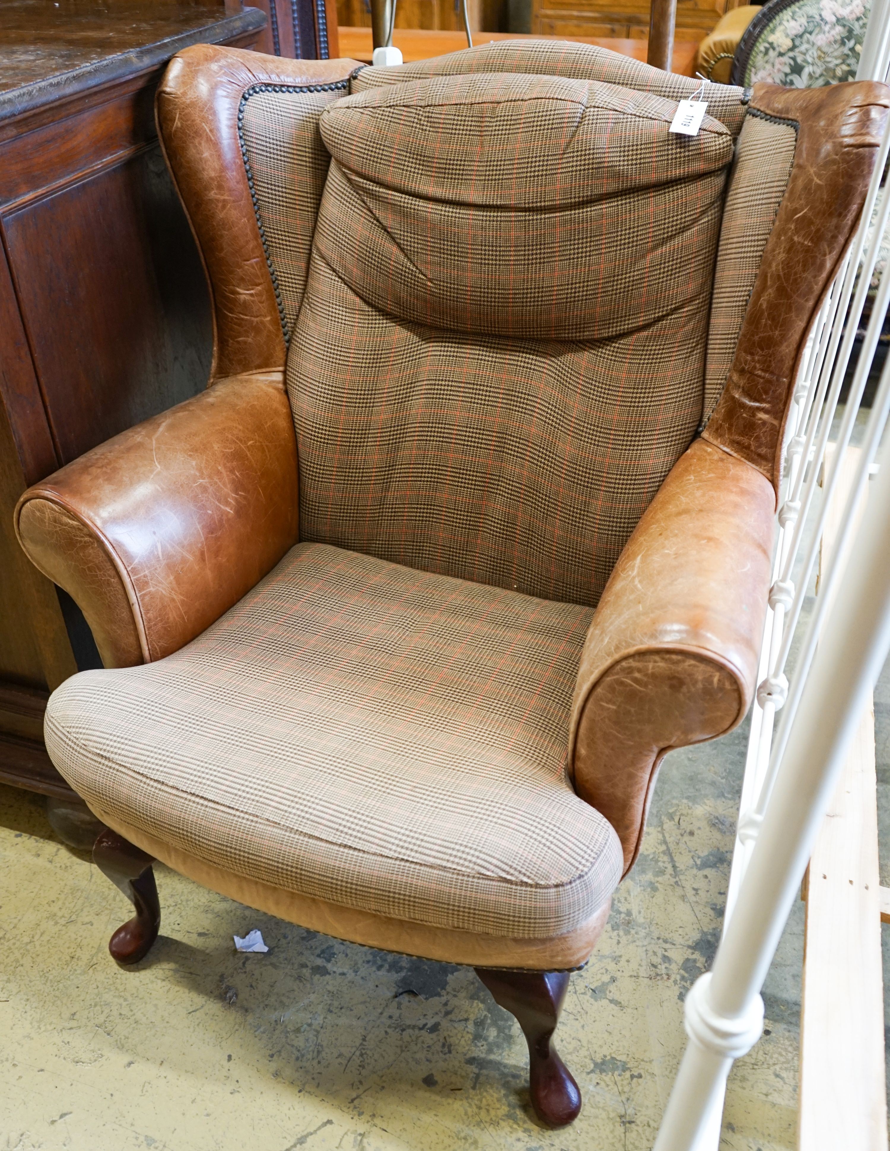 A Victorian style tweed and tan leather wing armchair, width 80cm, depth 84cm, height 98cm